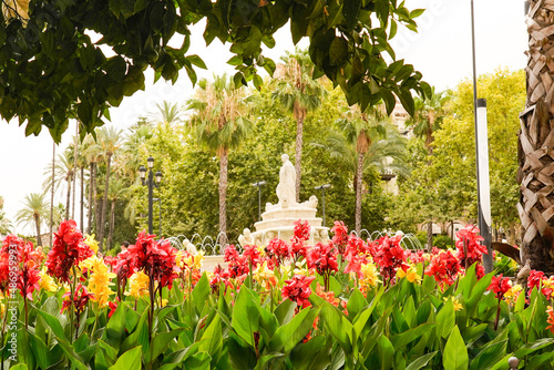 Colorful flowers adorn the Fuente de Sevilla, is a fountain located in the Puerta de Jerez. photo