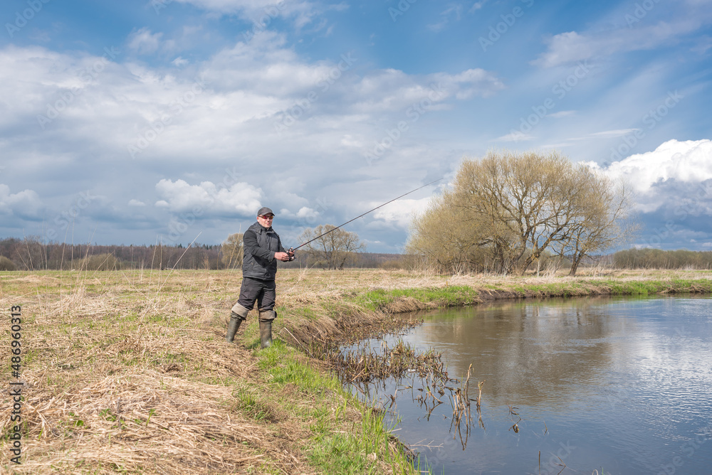 Fisher in a jacket with a fishing