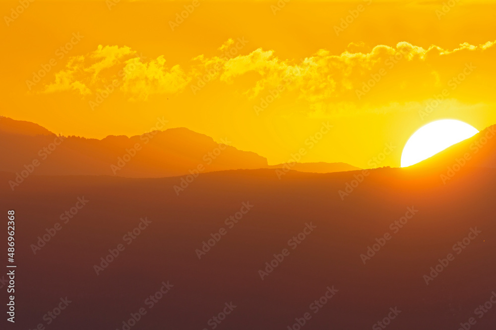 The sun rising early in the morning above the hills of Greece. The sun rising early in the morning above the hills of Greece.