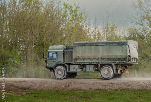 British army MAN SV 4x4 green army lorry logistics vehicle truck driving along a dirt track in action on a military exercise, Salisbury Plain UK