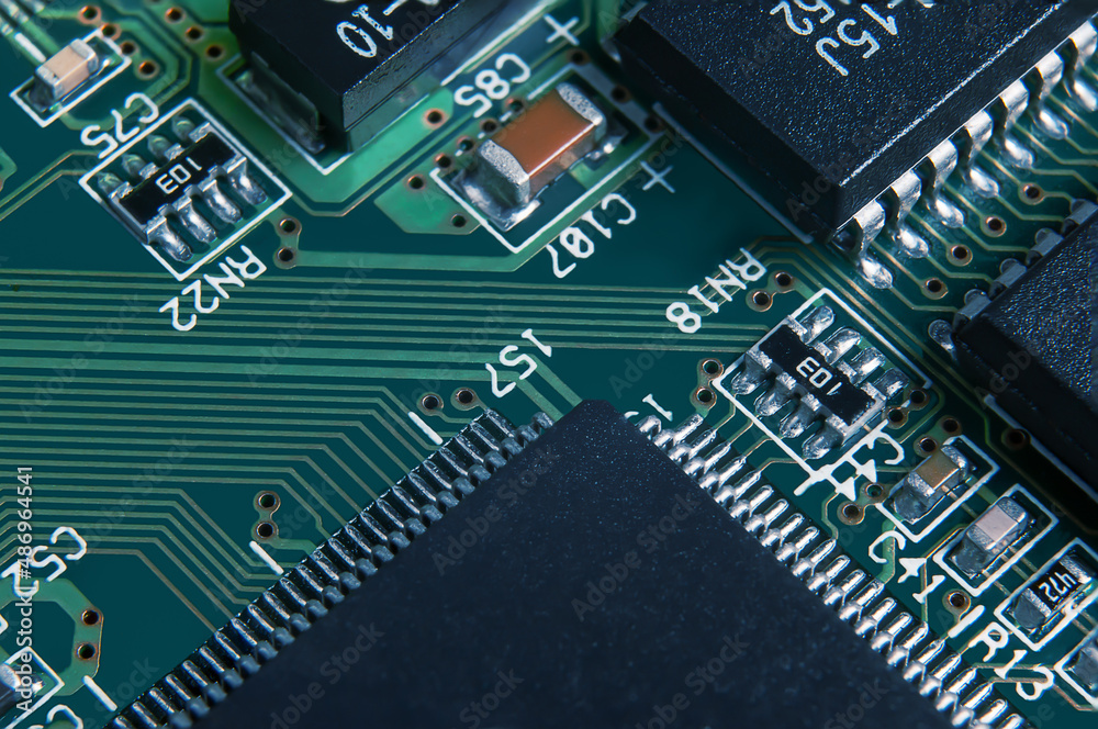 Closeup of Printed Circuit Board with processor, integrated circuits and many other surface mounted passive electrical components. Closeup of Printed Circuit Board with processor, integrated circuits and many other surface mounted passive electrical components.