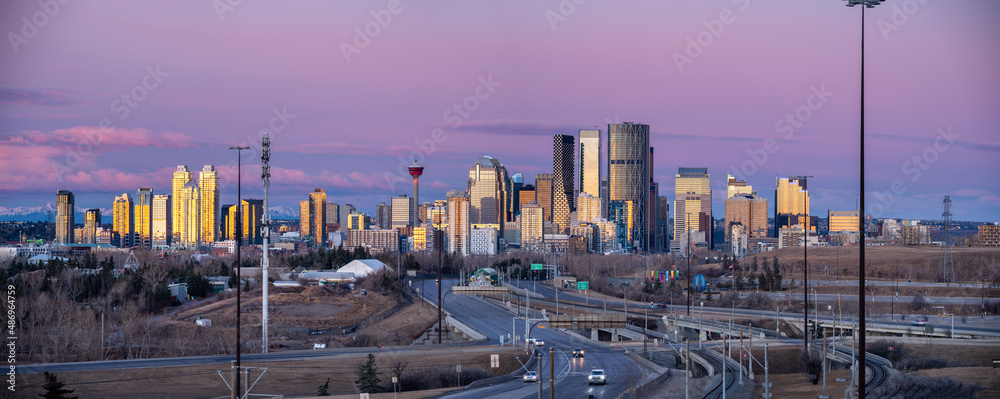 Panoramic view of Calgary's skyline at sunrise.