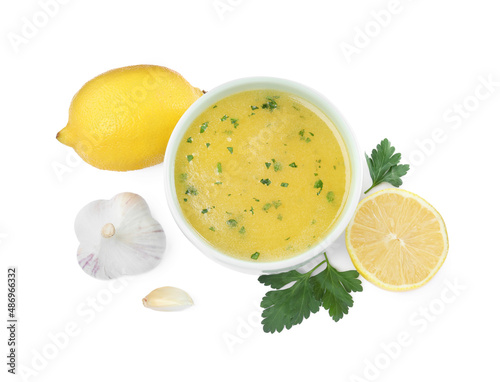 Bowl with lemon sauce and ingredients on white background, top view. Delicious salad dressing