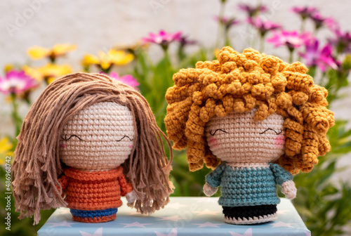 Photo crochet girl handmade dolls with a flower background