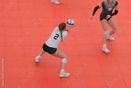 Volleyball liberal plays defense on orange tile court