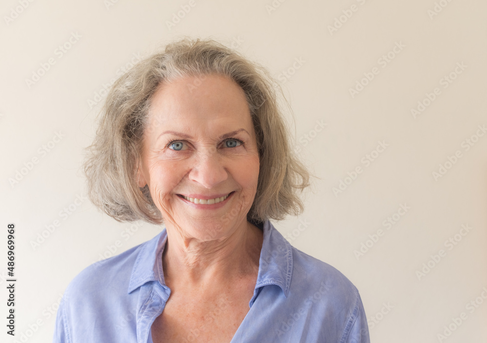 Portrait of smiling older woman with grey hair and blue eyes (selective focus) Portrait of smiling older woman with grey hair and blue eyes (selective focus)
