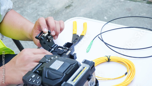  Wire connection with Fiber Optic Fusion Splicing machine,fiber optic cable splice machine in workTechnician Fiberoptic Fusion Splicing. Worker connecting for Cable Internet signal 