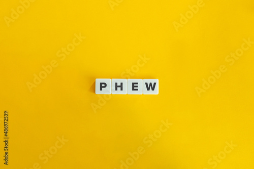 фотографія Phew Word on Letter Tiles on Yellow Background