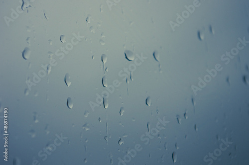 Natural summer background - raindrops on the window glass, close up.