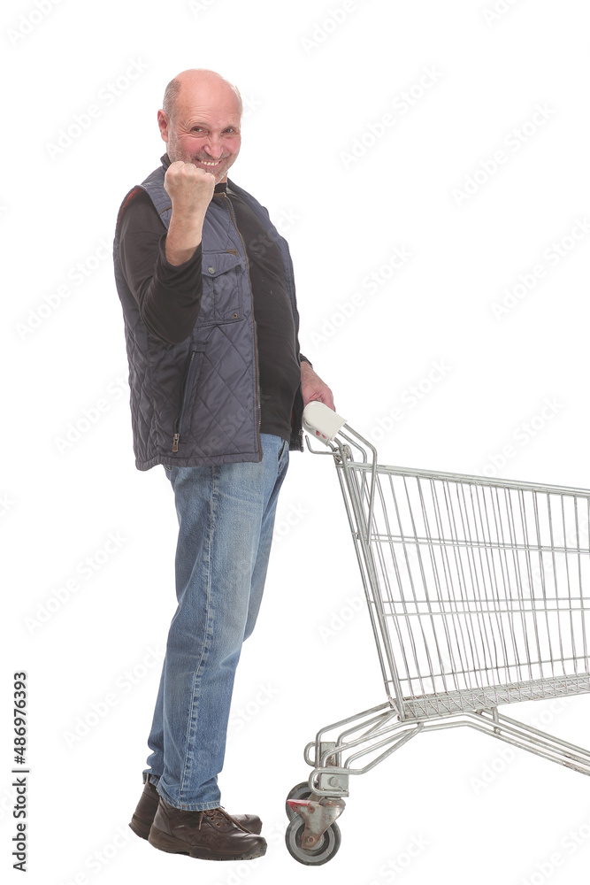 Full length potrait of a gentleman with shopping cart and thumb up Full length potrait of a gentleman with shopping cart and thumb up