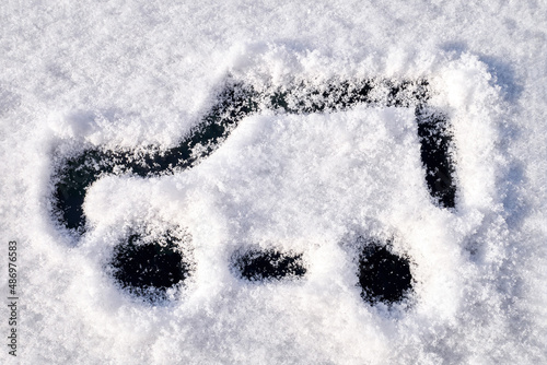 The simple image of the car is drawn on the fresh snow. Handwritten on the snow on a winter day.