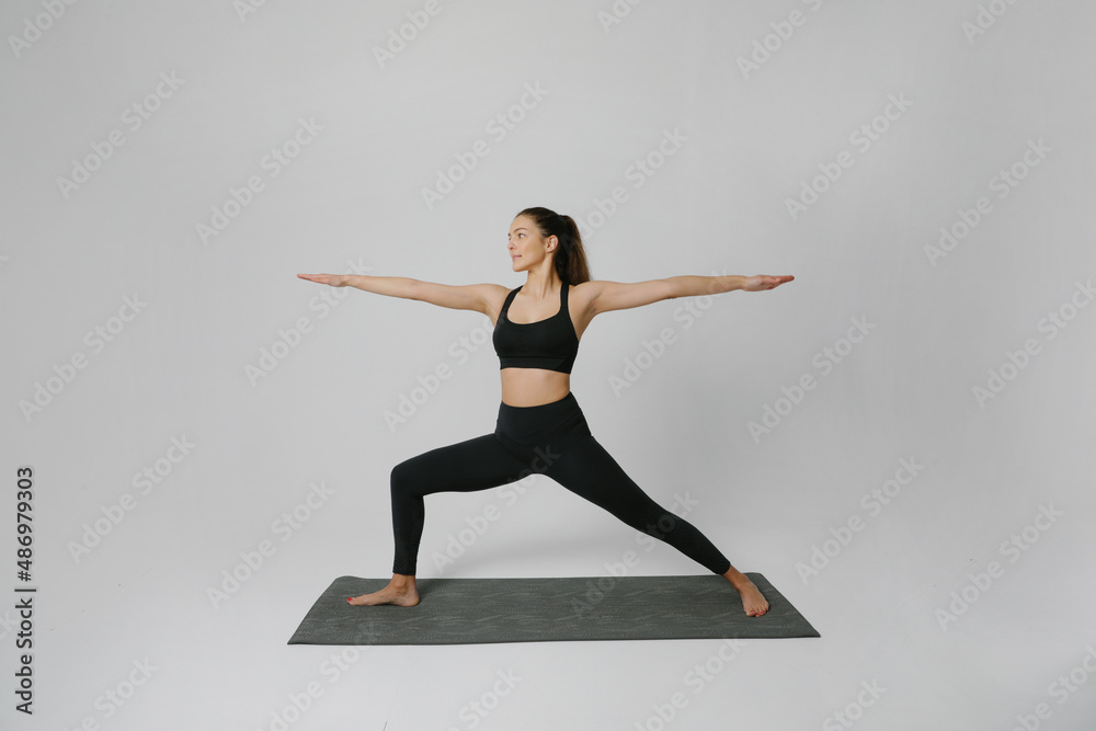 Portrait of young woman practicing yoga asana in studio. Calmness and relax.