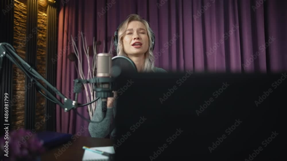 A beautiful blogger girl sings a song for her subscribers live. To do this, she uses a microphone, headphones and a portable laptop. The blonde sings her song delightfully. Live chat on the Internet. A beautiful blogger girl sings a song for her subscribers live. To do this, she uses a microphone, headphones and a portable laptop. The blonde sings her song delightfully. Live chat on the Internet.
