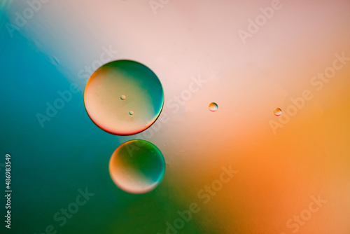 Several drops in light orange colors and teal coior background photo