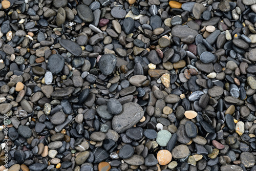Close-up of beach pebbles of various shapes and colors, background and textures