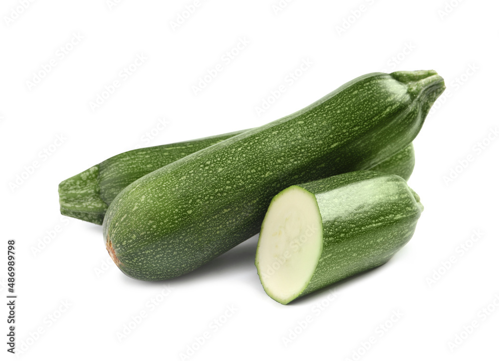 Whole and cut ripe zucchinis on white background Whole and cut ripe zucchinis on white background
