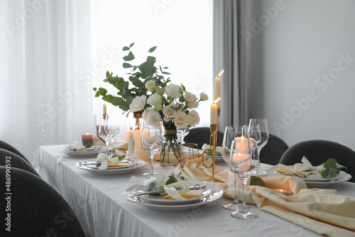 Festive table setting with beautiful floral decor in restaurant