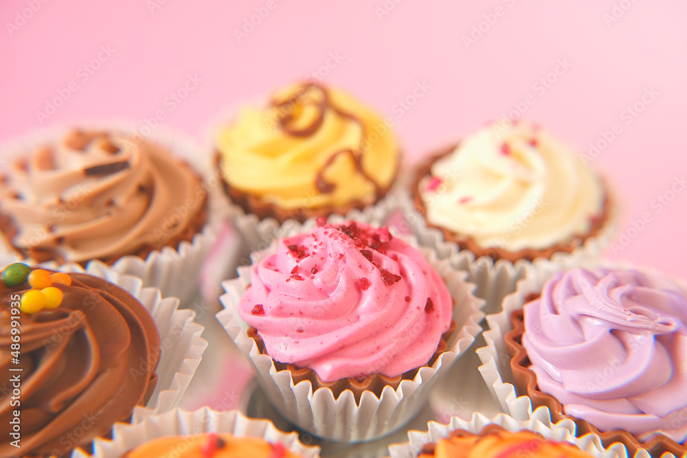 Cream cupcakes.cakes on a pink background.Cream dessert. Assorted sweet table. Sweets and desserts. Baked goods and desserts Cream cupcakes.cakes on a pink background.Cream dessert. Assorted sweet table. Sweets and desserts. Baked goods and desserts
