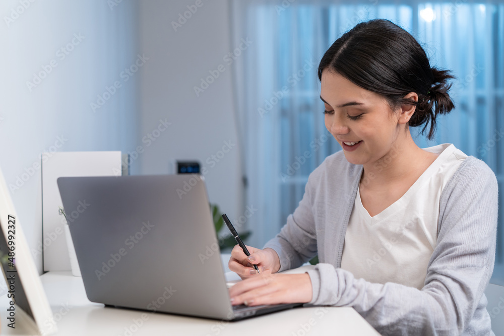 Asian young woman study virtual online and work in living room at home. Asian young woman study virtual online and work in living room at home.