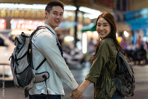 Portrait of Asian couple travel in city for honeymoon trip at night. 