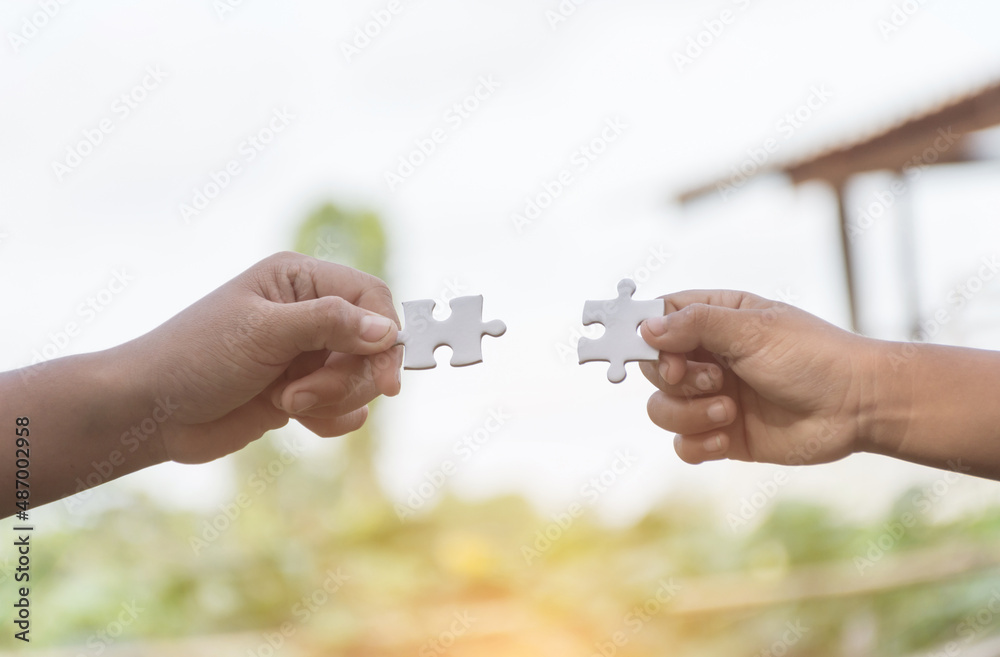 White jigsaw puzzle in child hand,team concept,soft focus. White jigsaw puzzle in child hand,team concept,soft focus.