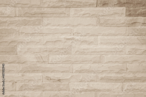Cream and beige brown brick wall concrete or stone texture background backdrop.