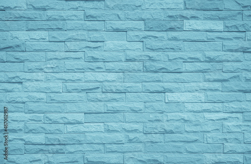 Brick wall painted with pale blue paint pastel calm tone texture background. Brickwork and stonework stack backdrop.