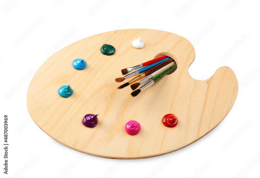 Wooden artist's palette with brushes and samples of paints isolated on white Wooden artist's palette with brushes and samples of paints isolated on white