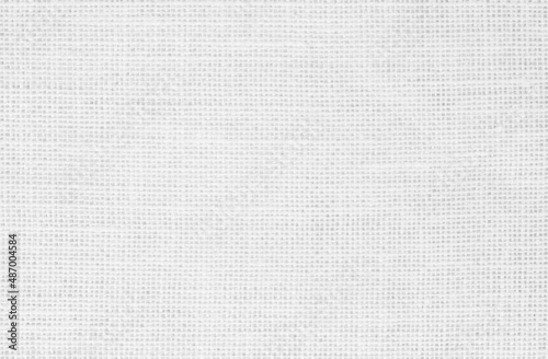 White fabric jute hessian sackcloth canvas woven gauze texture pattern in light white color blank. Natural linen and cotton cloth.