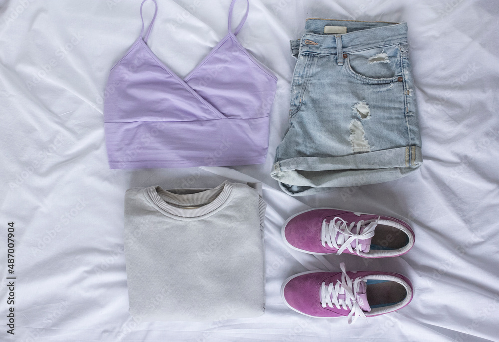 Female trendy clothes flat lay on white sheet background, look of the day Female trendy clothes flat lay on white sheet background, look of the day