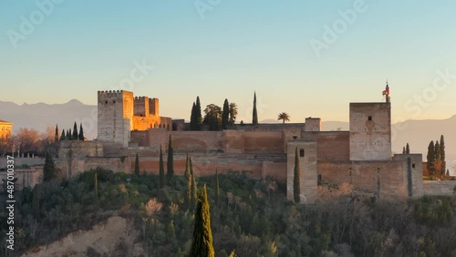 Panoramic view of the Alhambra citadel during sunset light with the Sierra Nevada in the background. photo