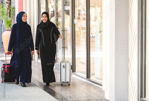 Two young asian fashion muslim woman enjoying shopping time summer sale walk and having fun talking together to buy something in the shop at fashion store © Art_Photo