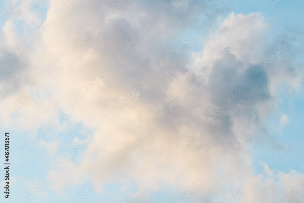 Obraz premium Background of blue sky with white pink clouds at sunset