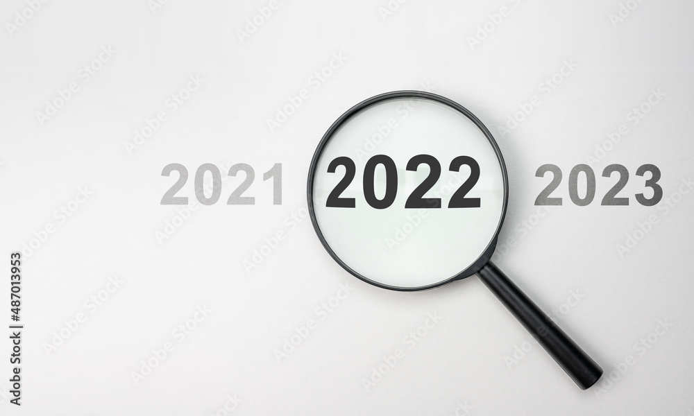 2022 inside of Magnifier glass on white background for focus current situation, positive thinking mindset concept. 2022 in focus. 2021 2022 2023 on white background, top view 2022 inside of Magnifier glass on white background for focus current situation, positive thinking mindset concept. 2022 in focus. 2021 2022 2023 on white background, top view