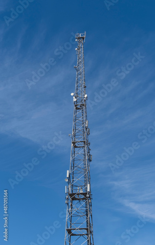 Base stations and antennas on metal telecommunications tower.