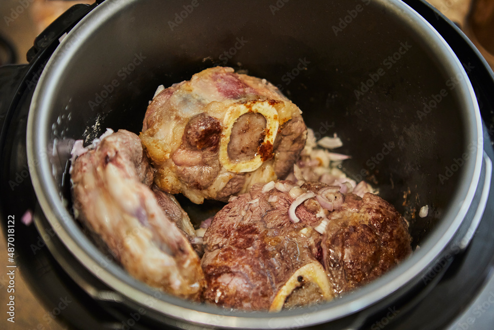 Ossobuco with spindle Beef is fried in pressure cooker. French gourmet cuisine