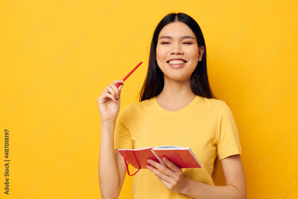 Portrait Asian beautiful young woman with a notebook and pen in hand Lifestyle unaltered Portrait Asian beautiful young woman with a notebook and pen in hand Lifestyle unaltered