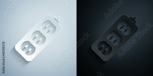 Paper cut Electric extension cord icon isolated on grey and black background. Power plug socket. Paper art style. Vector