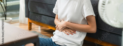 Photos woman hands holding the stomach and pain period cramps because having menstruation