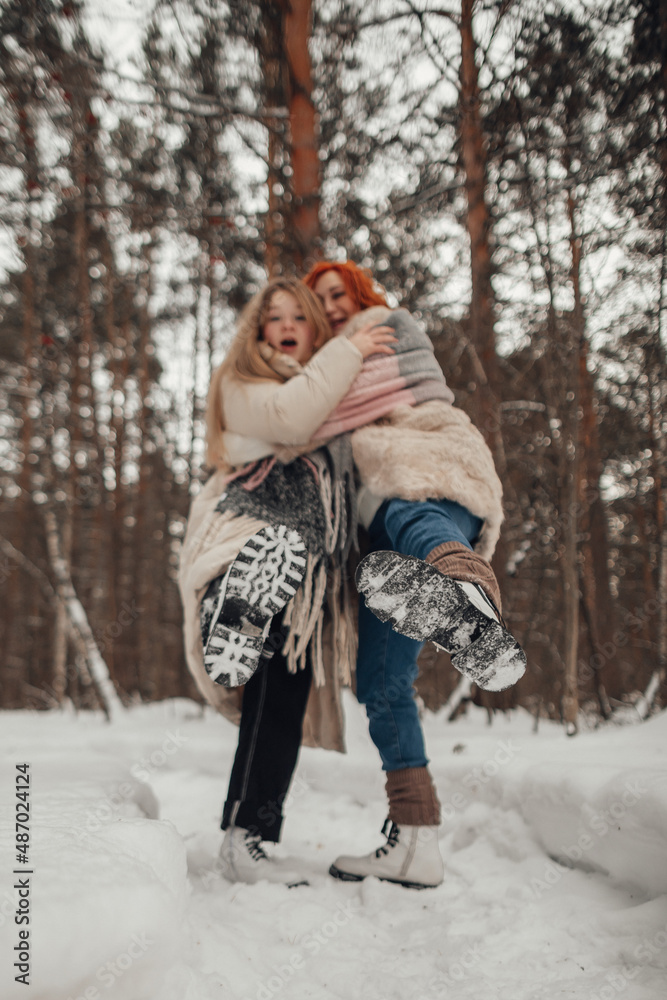 Two girls having fun in the winter forest Two girls having fun in the winter forest