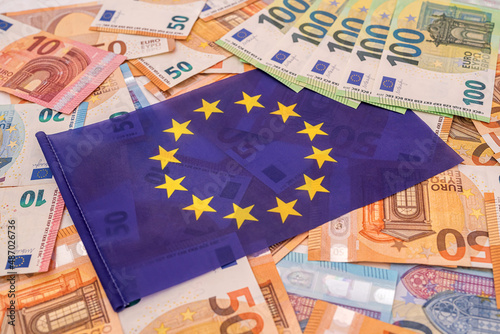 beautiful colored new euro banknotes on which lies the blue euro flag photo
