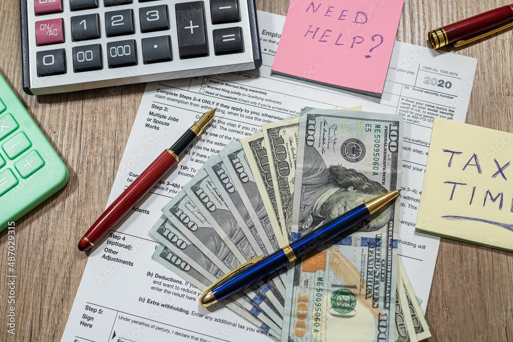 w4, w9 tax form is empty to fill with money dollars on the table. w4, w9 tax form is empty to fill with money dollars on the table.
