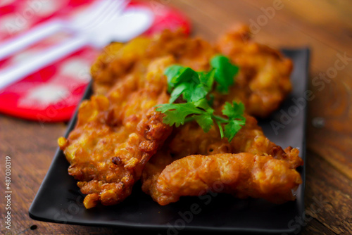 Corn Fritters With chili sauce placed on a wooden table