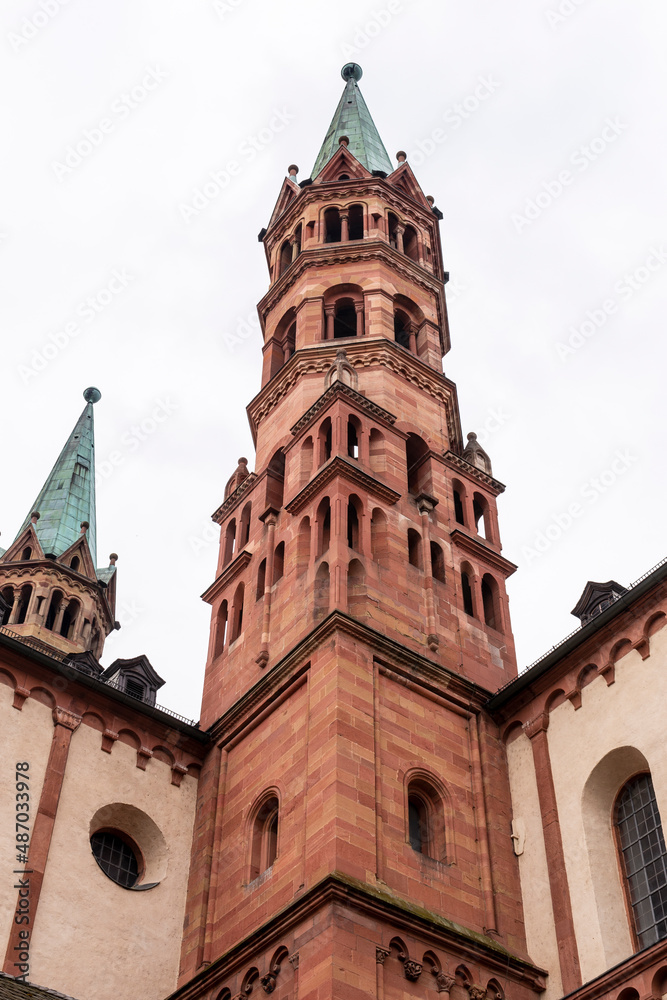 Brick colored towers with bronze green roofs at Würzburger Cathedral or Würzburger Dom seen in frog perspective from the nave side