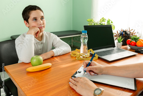Obesity, health problem, weight loss. Prescribing diet for overweight fat patient. Child eating stealthily high calorie foods. Doctor advising a fat boy to eat healthy. Doctor warning of consequences.