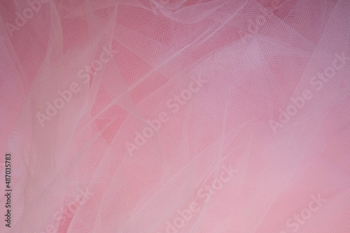 delicate airy white fabric with folds on a pink background