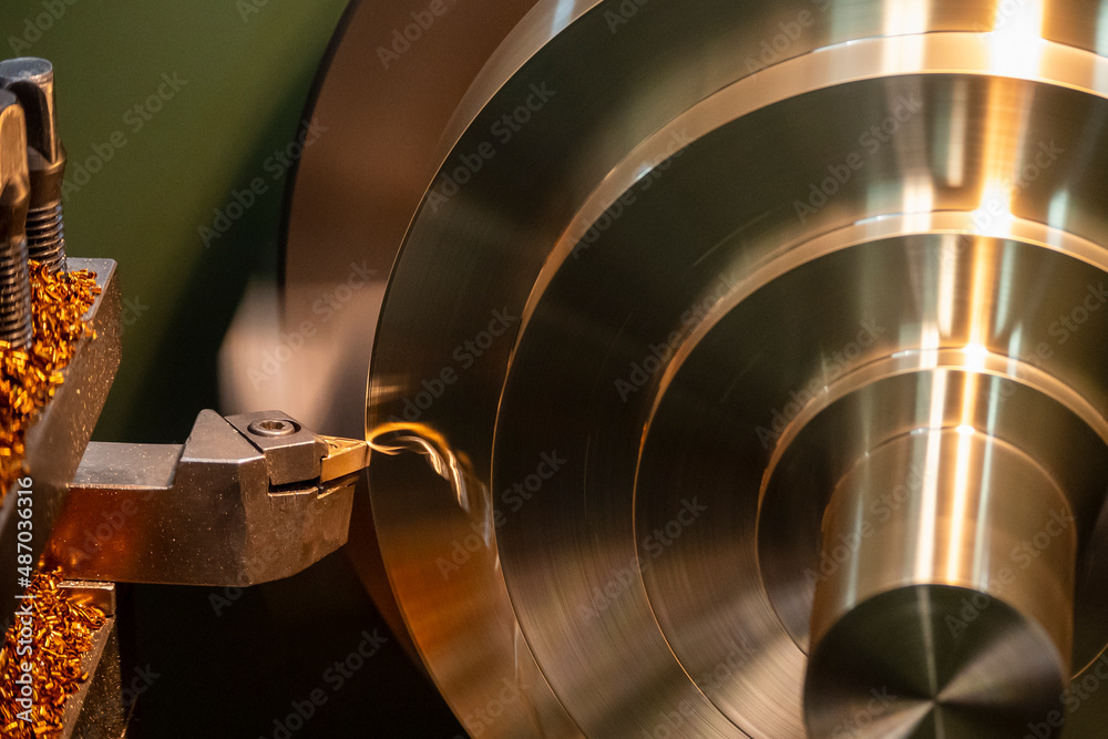 Closeup scene the lathe machine finishing cut the brass shaft parts by lathe tools. Closeup scene the lathe machine finishing cut the brass shaft parts by lathe tools.