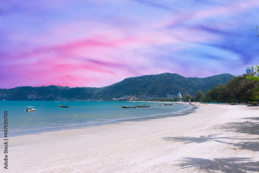Obraz premium Long tail Boat on colourful sunset over a Beach in Phuket Thailand