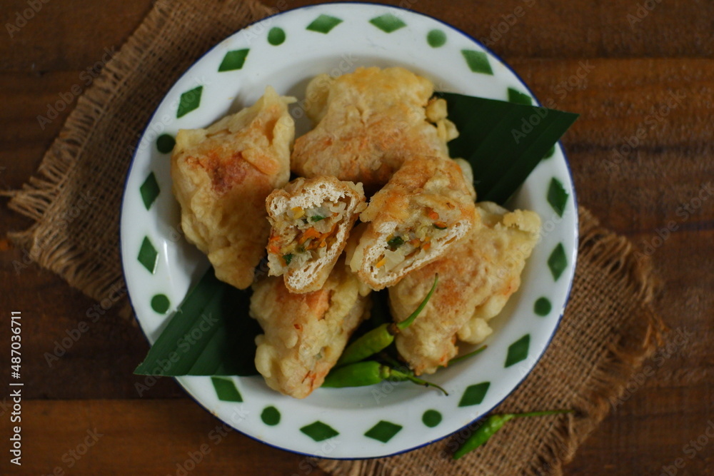a plate of fried tofu filled with vegetables named tahu isi in Bahasa a plate of fried tofu filled with vegetables named tahu isi in Bahasa