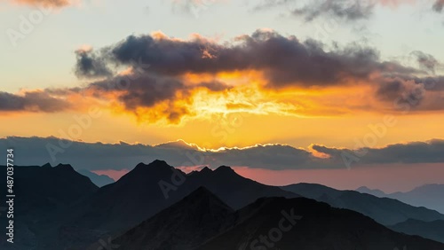 Amazing Orange Sunset Through Clouds Over French Alps Mountains